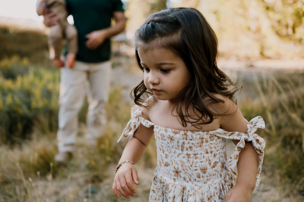 Little girl chasing wildflowers during corvallis family session